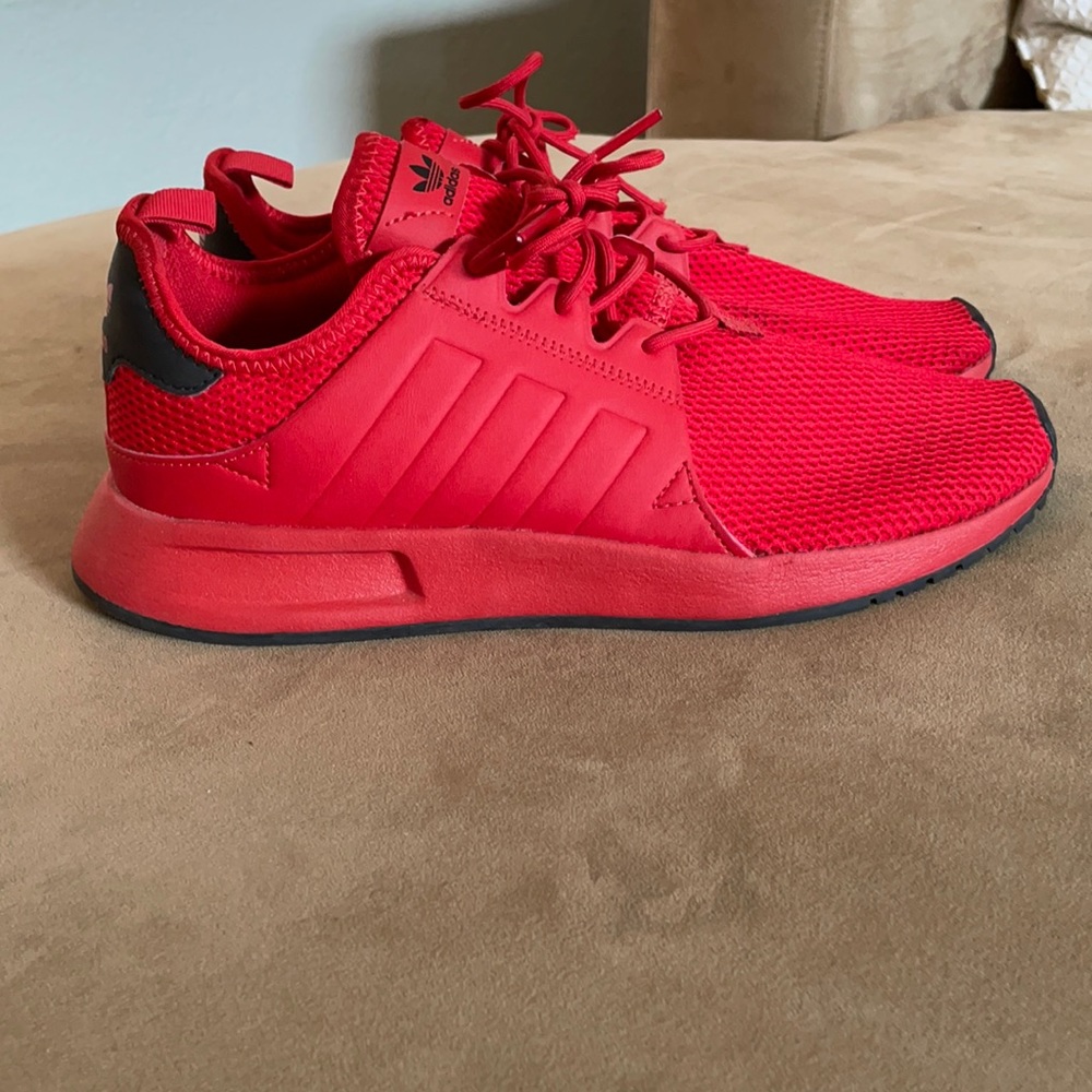Red Adidas athletic shoes